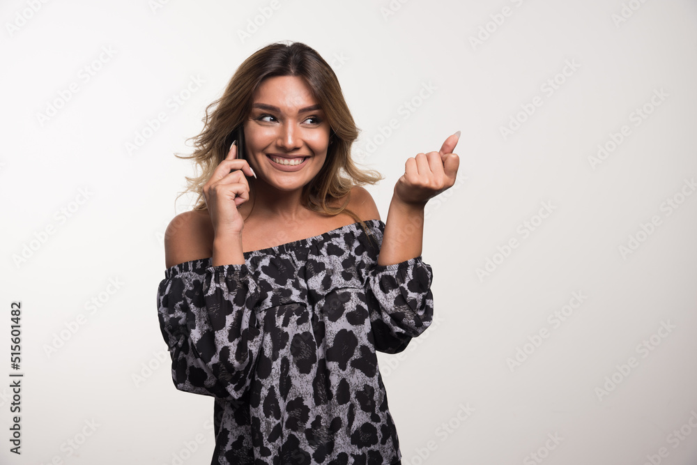 Young woman talking with telephone happily on white background Young woman talking with telephone happily on white background