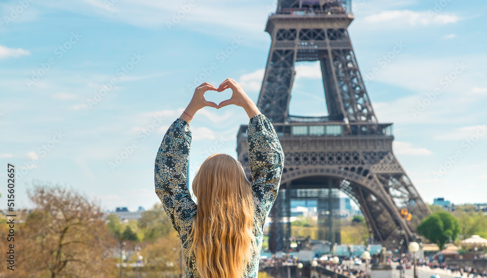 Woman near the eiffel tower. Selective focus.