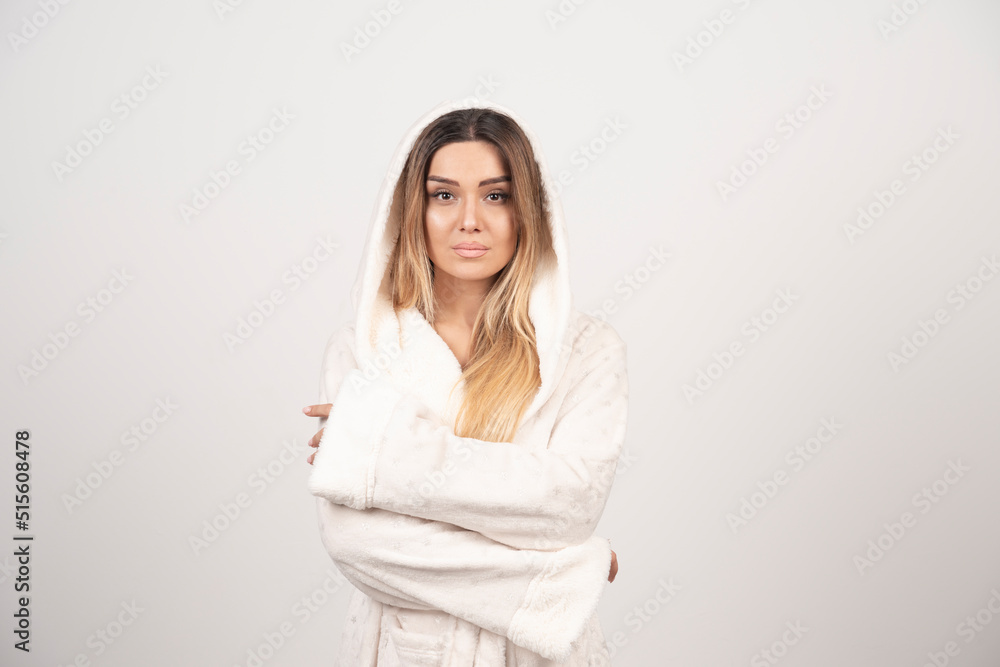 Beautiful young woman in a white bath robe isolated on white background Beautiful young woman in a white bath robe isolated on white background