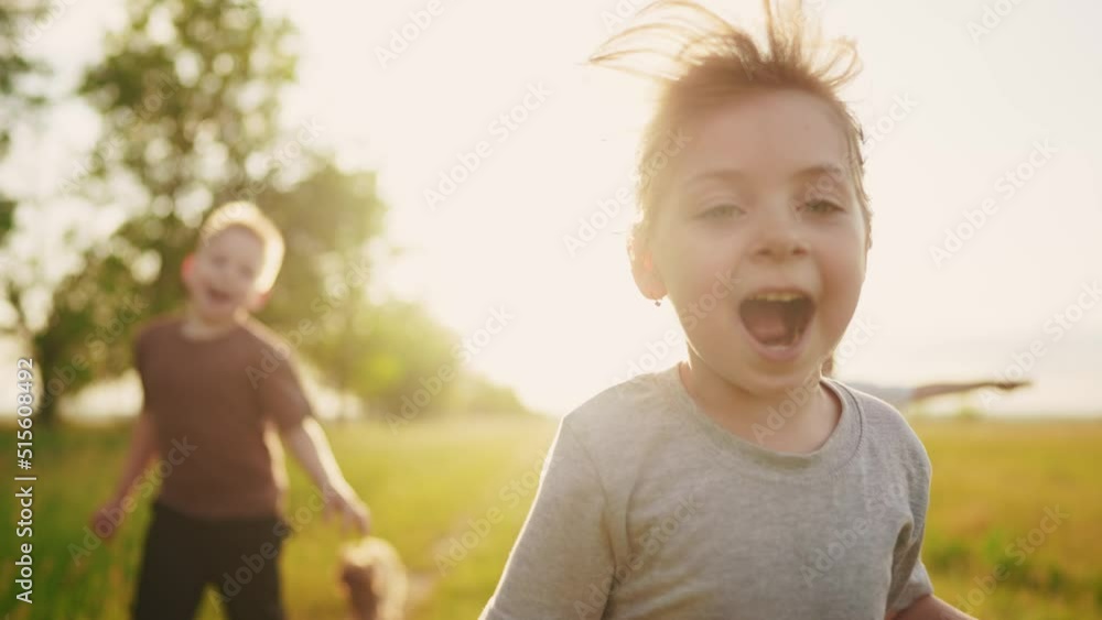 children in the park. a group of children in a team hands to the sides ...