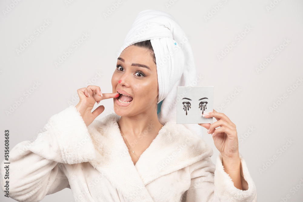 Portrait of woman wrapped in white towel with eye shadow palette Portrait of woman wrapped in white towel with eye shadow palette