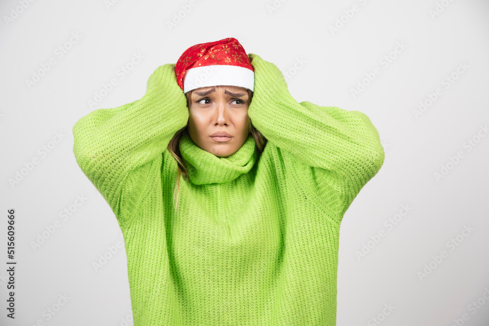 Young woman posing in Santa Claus red hat Young woman posing in Santa Claus red hat
