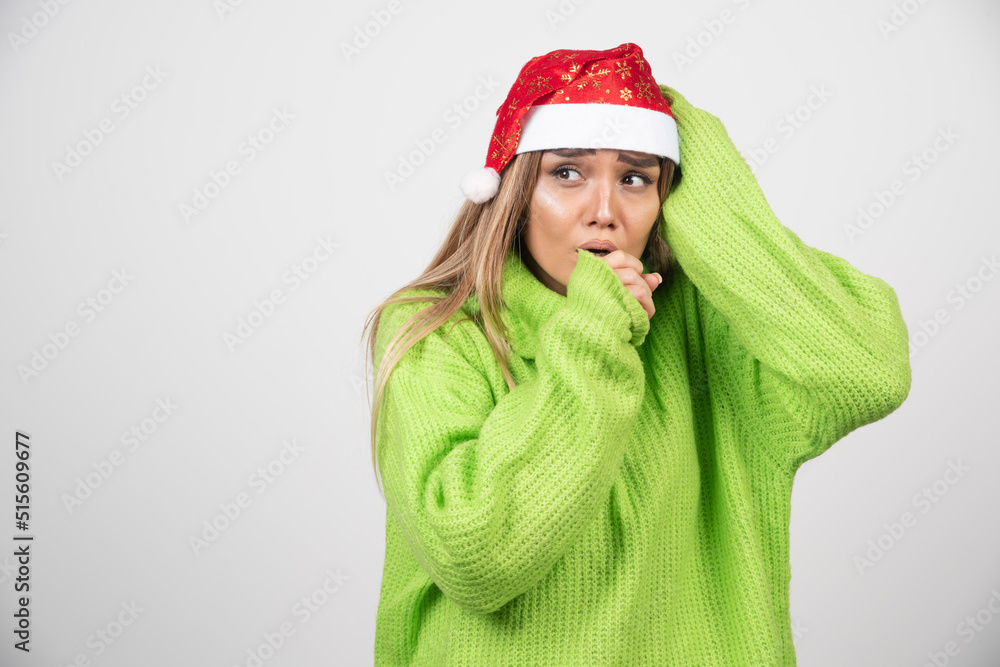 Young woman posing in Santa Claus red hat