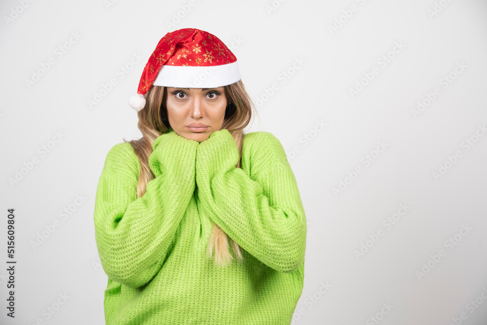 Young woman posing in Santa Claus red hat Young woman posing in Santa Claus red hat