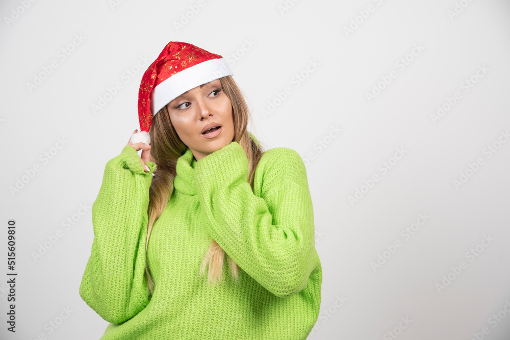Young woman posing in Santa Claus red hat Young woman posing in Santa Claus red hat