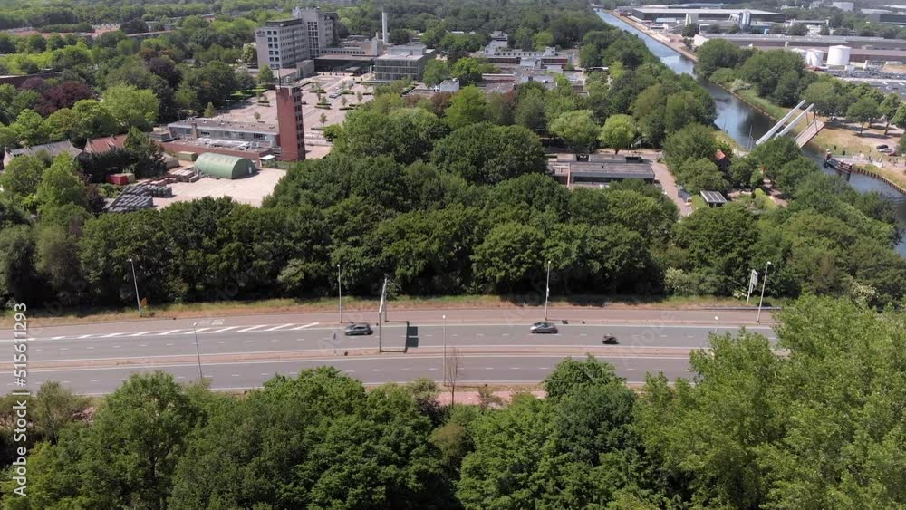 drone aerial view flying over a road towards the city Tilburg Netherlands, with a busy roundabout and adjacent neighborhood drone aerial view flying over a road towards the city Tilburg Netherlands, with a busy roundabout and adjacent neighborhood
