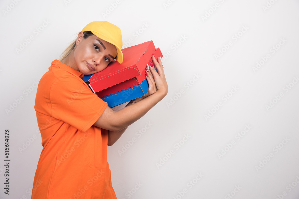 Pizza delivery woman holding pizza boxes with both hands on white background Pizza delivery woman holding pizza boxes with both hands on white background