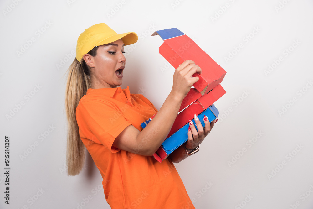 Pizza delivery woman opening pizza box with happy face on white background Pizza delivery woman opening pizza box with happy face on white background