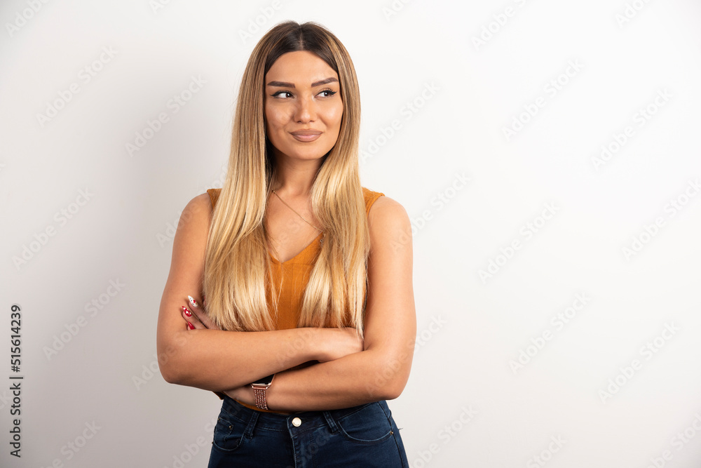 Pretty woman posing with crossed arms on white background