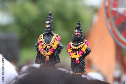 Warkari Carrying Vitthal Rukmin Statue on head in Wari to Pandharpur