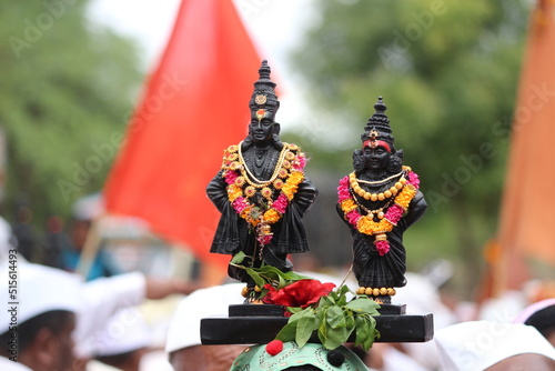 Warkari Carrying Vitthal Rukmin Statue on head in Wari to Pandharpur