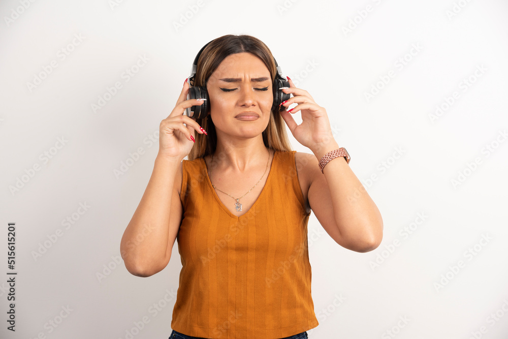 Young woman girl in casual clothes posing with headphones Young woman girl in casual clothes posing with headphones