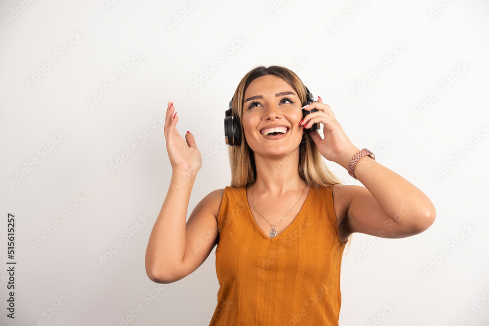 Young beautiful woman wearing headphones over white background Young beautiful woman wearing headphones over white background