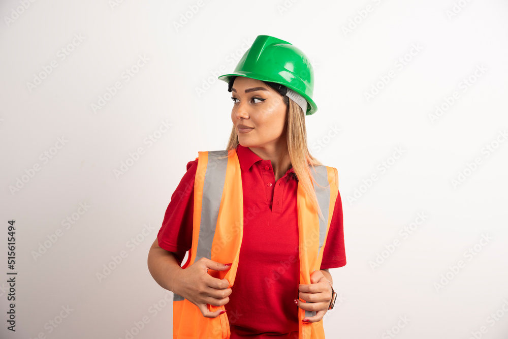 Portrait of a female worker posing with helmet on white background Portrait of a female worker posing with helmet on white background