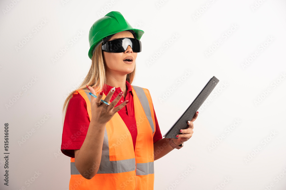 Shocked woman worker holding a clipboard