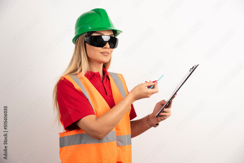 Woman employee showing with pencil on clipboard Woman employee showing with pencil on clipboard