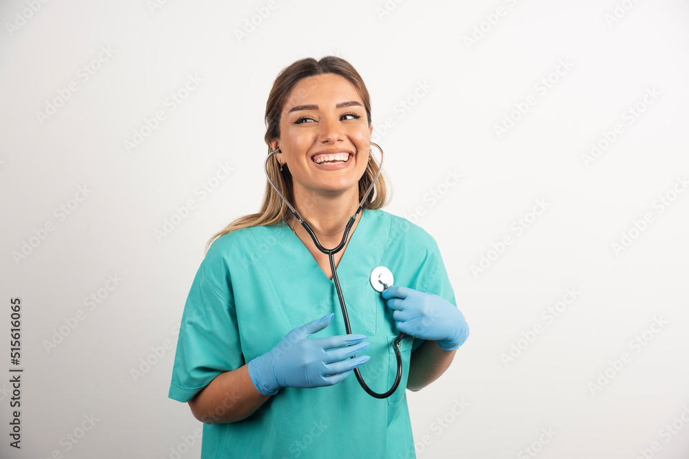 Young smiling female nurse posing with stethoscope Young smiling female nurse posing with stethoscope