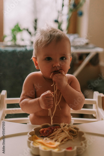 Cute baby eating spaghetti photo