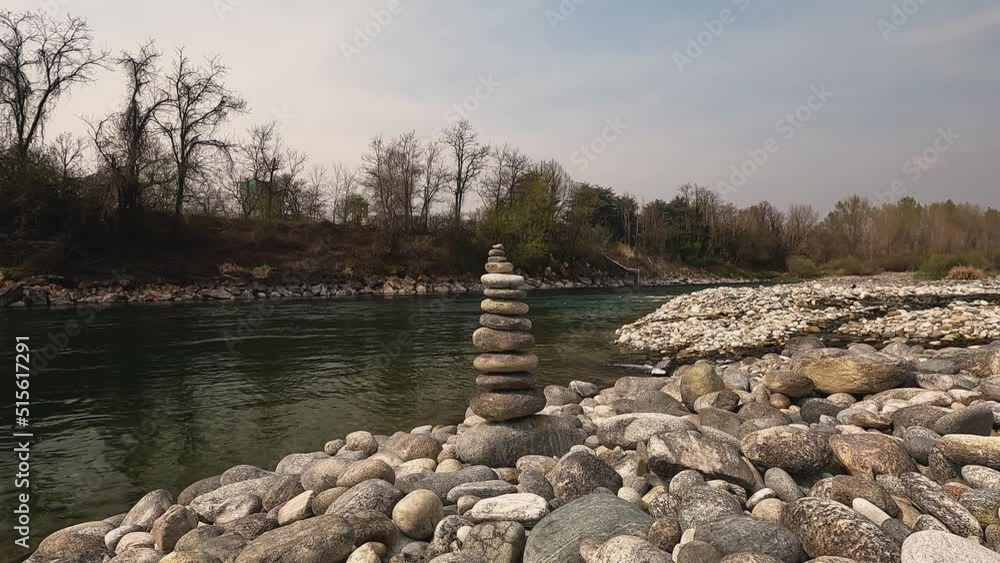 stone balance poised along the river stone balance poised along the river