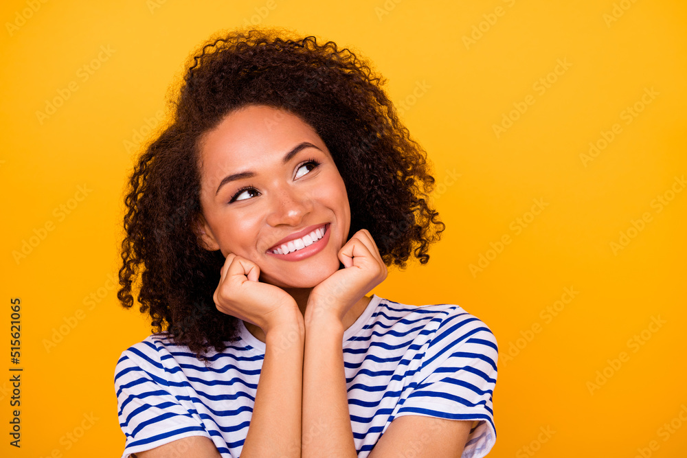 Photo of adorable thoughtful girl dressed striped t-shirt looking empty space arms cheeks isolated yellow color background Photo of adorable thoughtful girl dressed striped t-shirt looking empty space arms cheeks isolated yellow color background