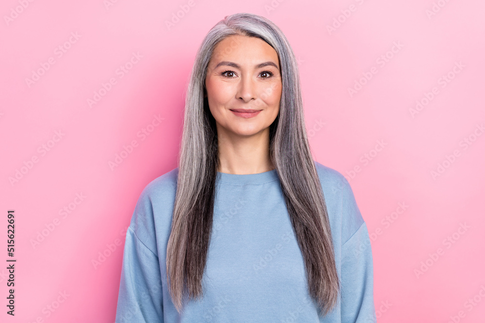 Photo of charming shiny retired woman blue sweater smiling isolated pink color background Photo of charming shiny retired woman blue sweater smiling isolated pink color background