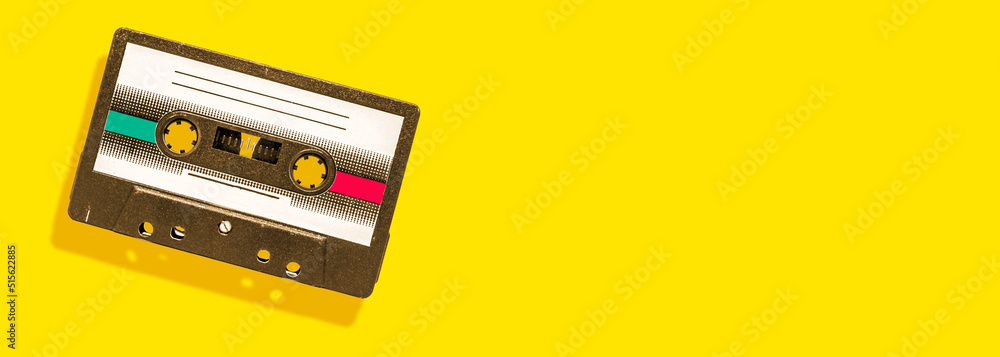 Fototapeta premium vintage audio cassette on yellow background with copy space