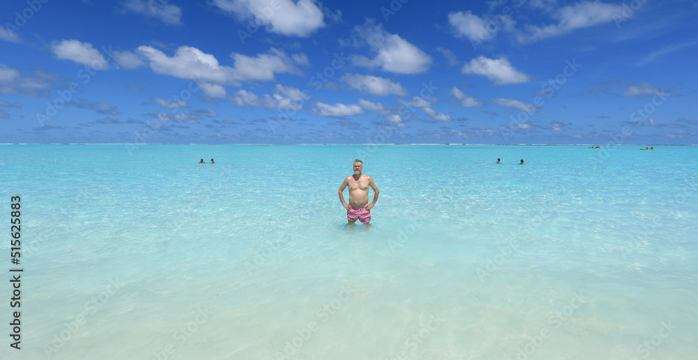 one man on a tropical island with white sand in the ocean