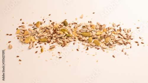 Mix of seeds for a salad. A pile of mixed seeds isolated on white background.