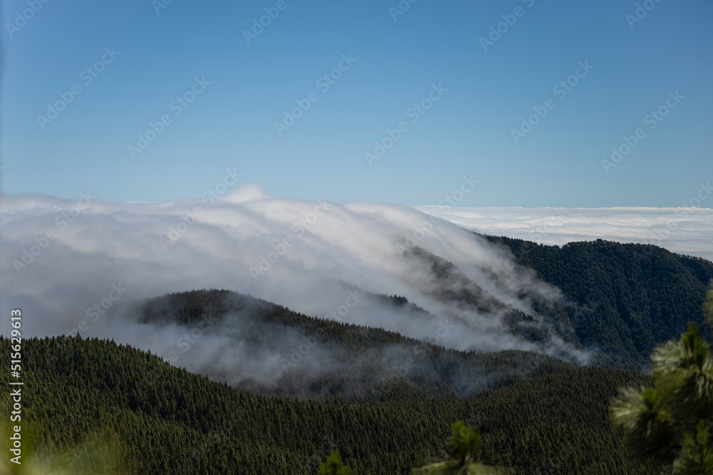 Fog flows down the mountain like river