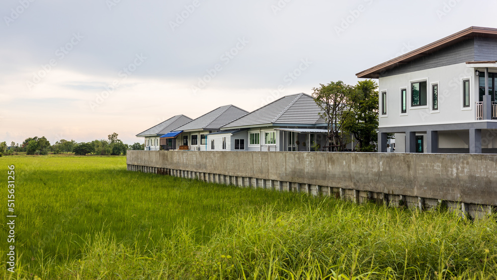 View of a modern residential housing estate with concrete fence walls that stretch. View of a modern residential housing estate with concrete fence walls that stretch.