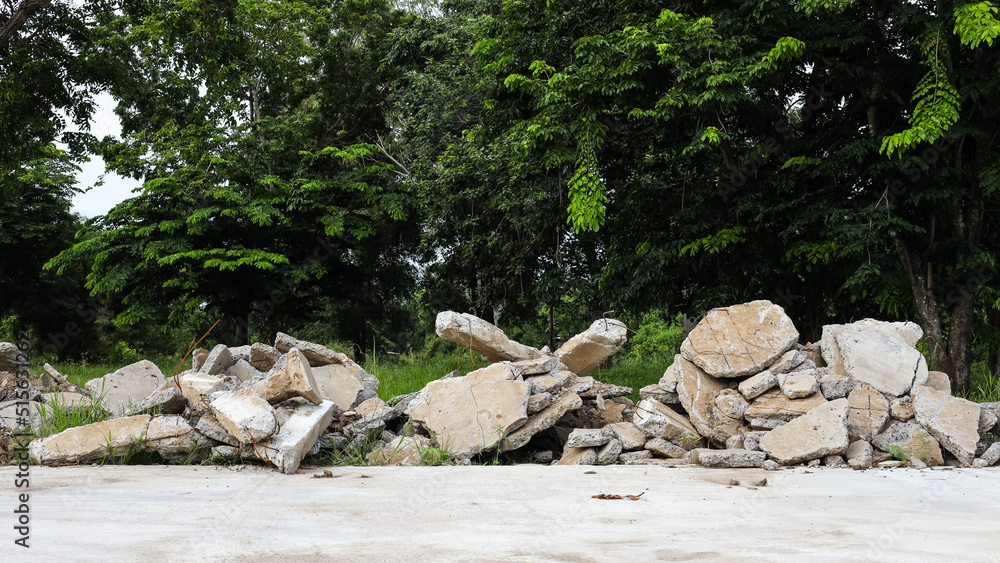 View of the rubble pile of concrete blocks demolished from the road surface and dumped.