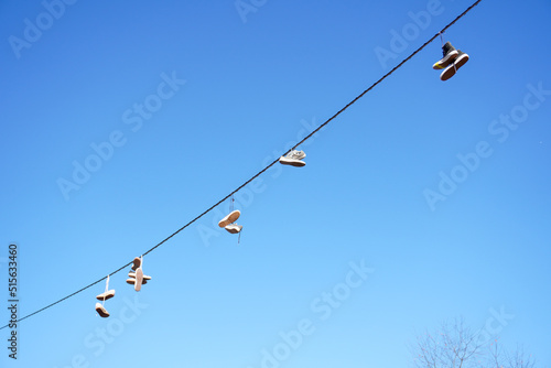 Shoes Hanging From Wire and Sign