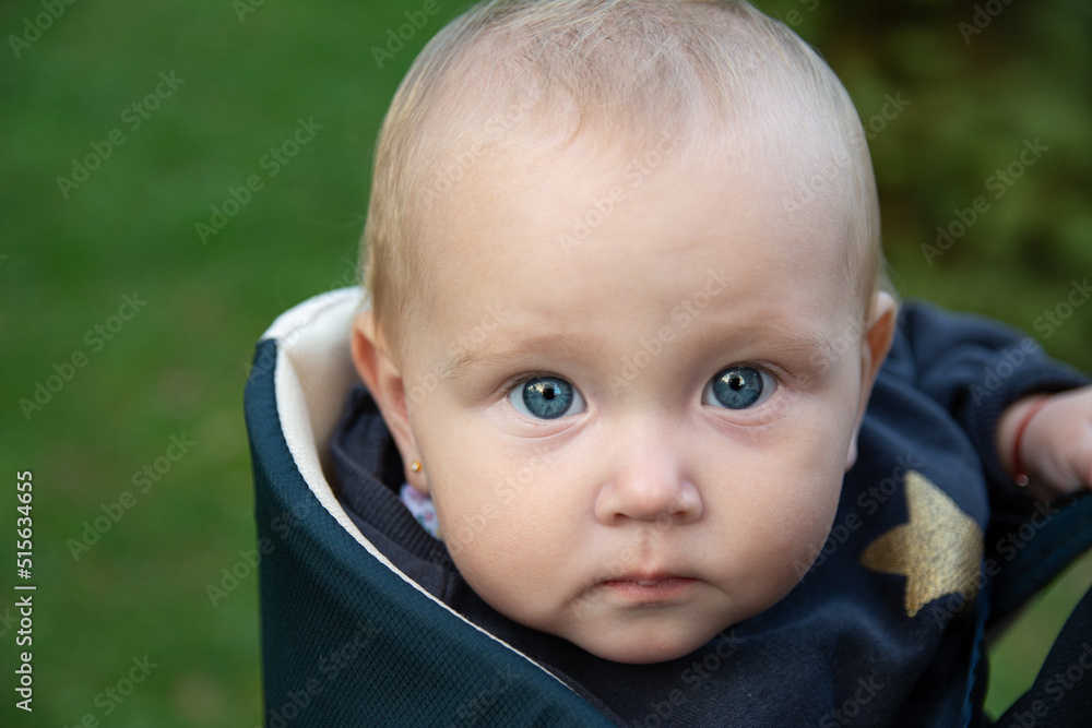 Portrait of a beautiful baby girl. The baby looks into the camera with beautiful blue eyes. Portrait of a beautiful baby girl. The baby looks into the camera with beautiful blue eyes.