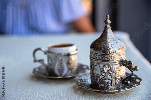 Turkish coffee in a beautiful traditional cup with a stylish lid. Beautiful serving of coffee in a Turkish cafe.