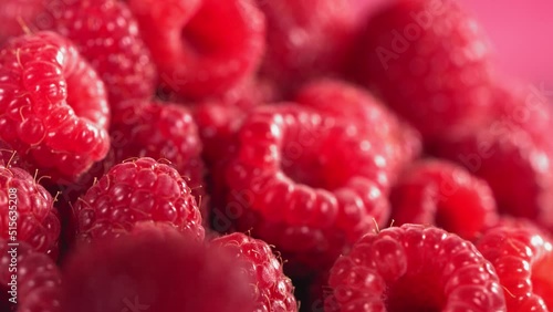 Ripe juicy Raspberry rolling above many Raspberries