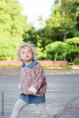 Portrait of a pretty confident little girl in a summer park © smallblackcat