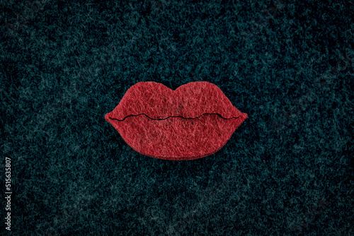 Big red plumpy lips on black background. Beauty concept