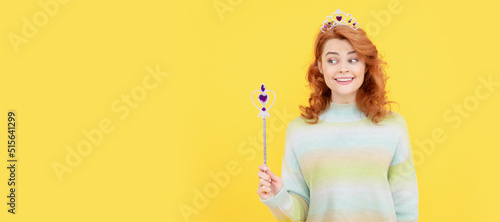Photography happy redhead woman in queen crown with magic wand, magic