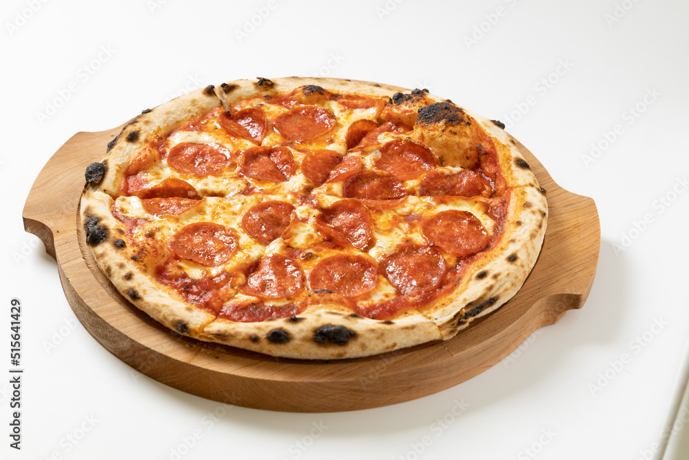 italian pizza with salami on a white background italian pizza with salami on a white background