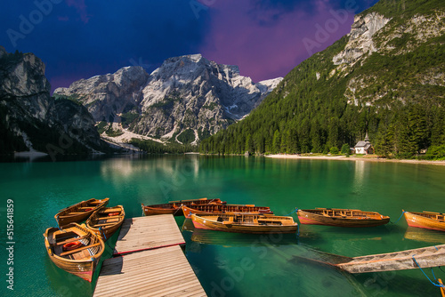 Romantic view of Braies Lake during sunset with summer forest and dolomites reflected in surface of water, Alto Adige, Italy