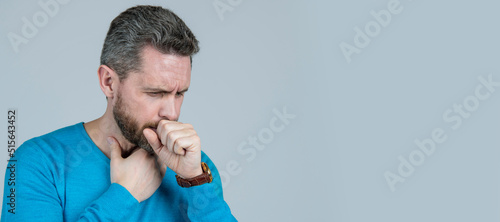 Man face portrait, banner with copy space. sick man has cough on grey background. mens health. male casual. photo