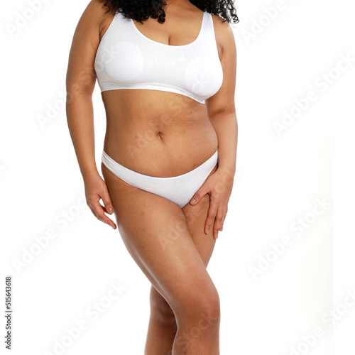 Woman with fat abdomen, overweight female body on white background, studio shot,posing in lingerie on a white background