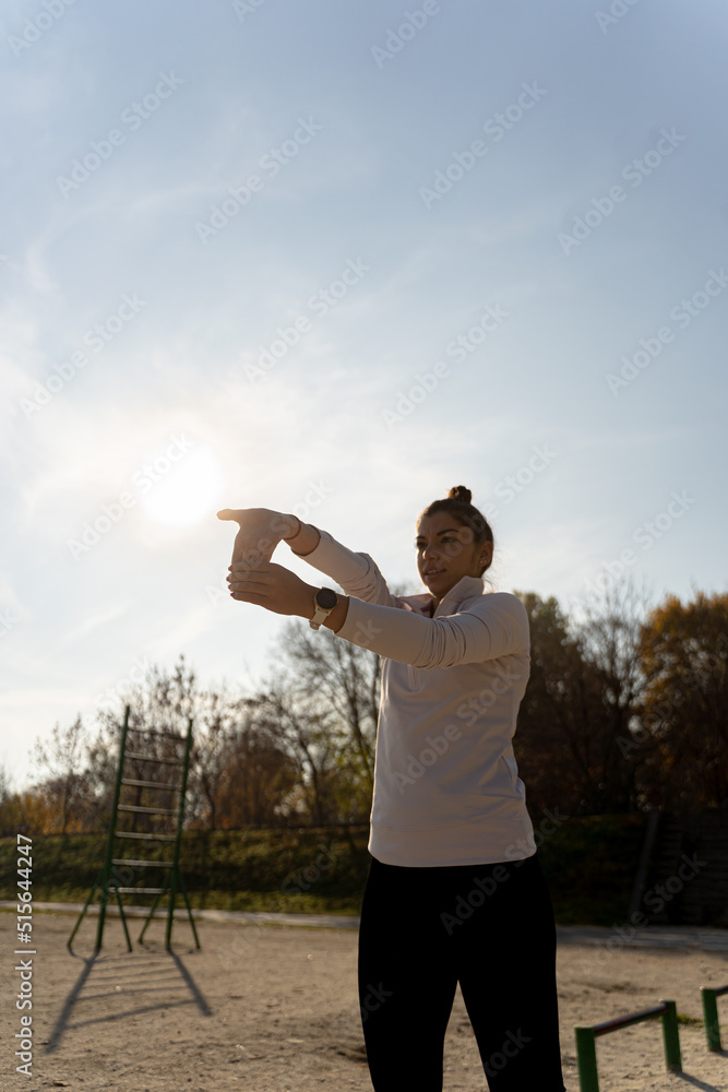 Fototapeta premium Stretching her hand before training outside