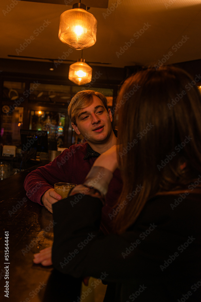 Flirting with each other on the bar while talking