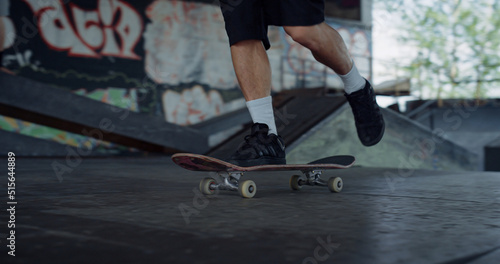 Extreme teenager skateboarding in urban skatepark. Teenager riding on skate. 