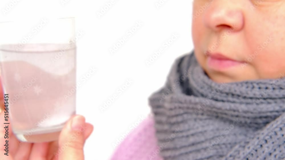 close-up of mature charismatic woman 50 years drinks clean water with effervescent tablet from glass, takes pill, concept most important element for life, human health, quench thirst