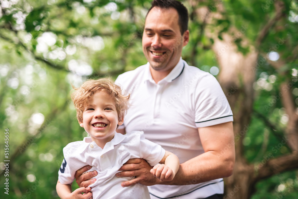 Father with his son having fun outside in forest Father with his son having fun outside in forest