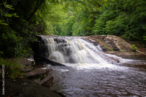 Waterfall in forest cascading down rocks slow shutter speed horizontal