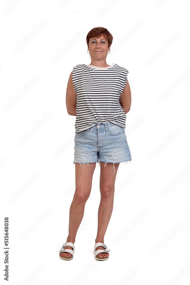 front view of a full portrait of a middle aged woman looking at camera and arms on back on white background front view of a full portrait of a middle aged woman looking at camera and arms on back on white background