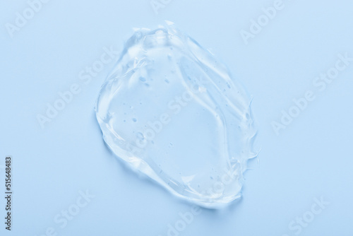 Cosmetic skin care gel serum smear with bubbles isolated on blue background top view © nevodka.com